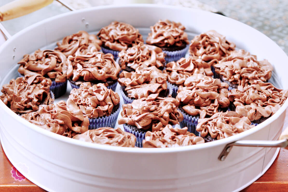 Rich chocolate buttercream frosting on cupcakes